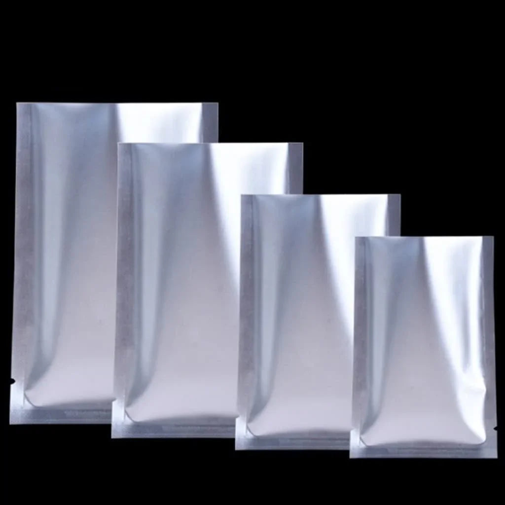 Silver aluminum foil pouches in assorted sizes, ideal for custom flexible packaging and wholesale use.