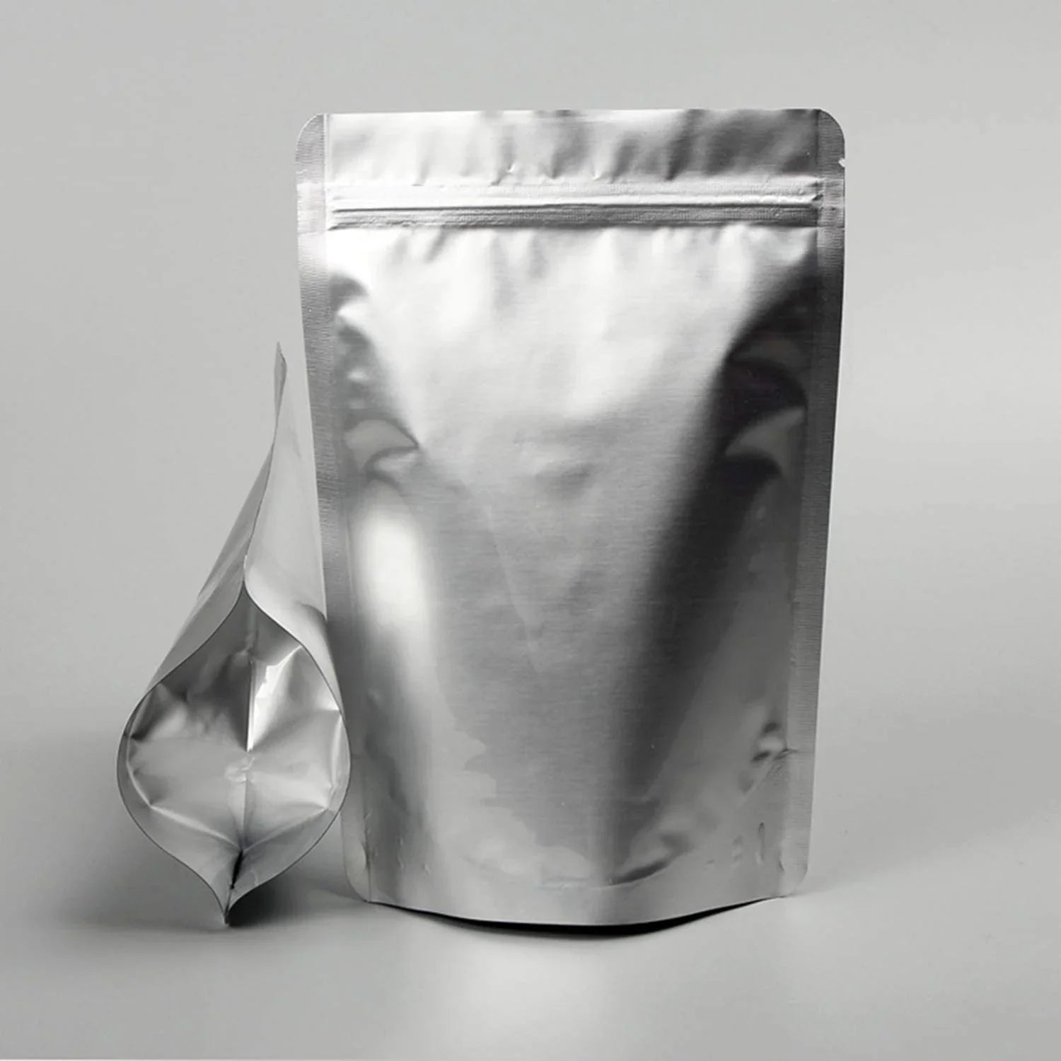 Shiny silver stand-up zipper pouch with resealable top, ideal for premium product packaging