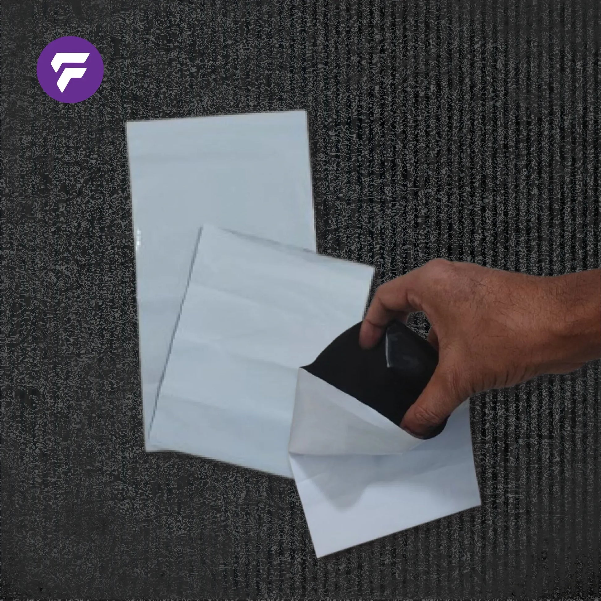 Hand holding white stand-up pouch with black interior, showcasing flexible packaging material