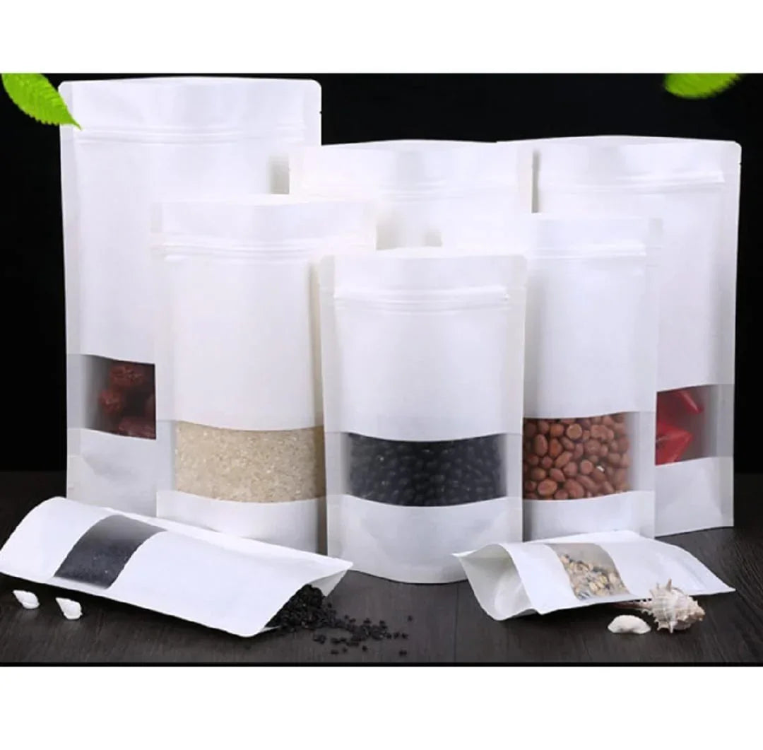 White stand-up zipper pouches with clear windows, filled with grains, beans, and snacks for food packaging.
