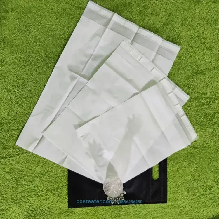 White stand-up zipper pouches on green turf, ideal for custom flexible packaging and wholesale branding