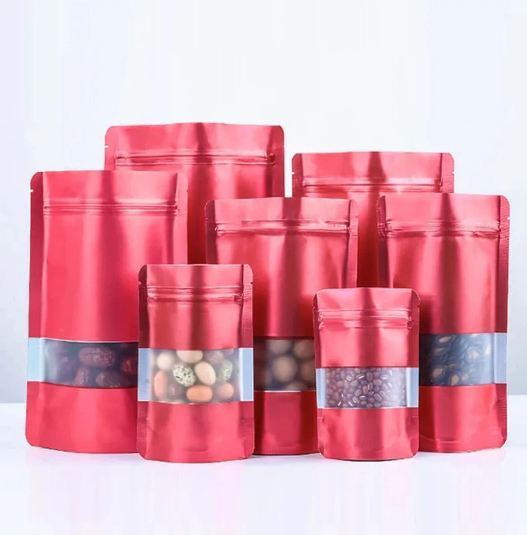 Red stand-up zipper pouches with clear windows, ideal for snacks, coffee beans, and custom packaging