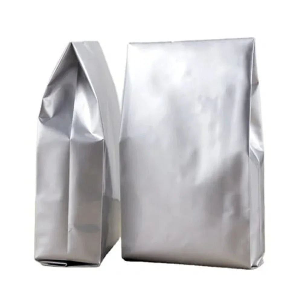 Silver stand-up aluminum foil pouches for premium food packaging, ideal for wholesale custom branding.
